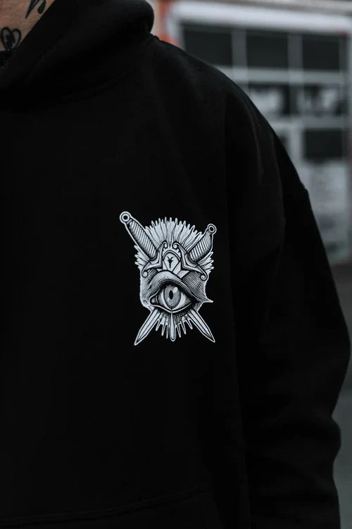 Front detail of Think Twice hoodie showing eye and dagger graphic over heart
Tattoo-style eye and dagger illustration on chest of black streetwear hoodie
Minimal chest artwork on hoodie – all-seeing eye with gothic dagger
Surreal front graphic of eye, dagger, and crown – tattoo-inspired streetwear
