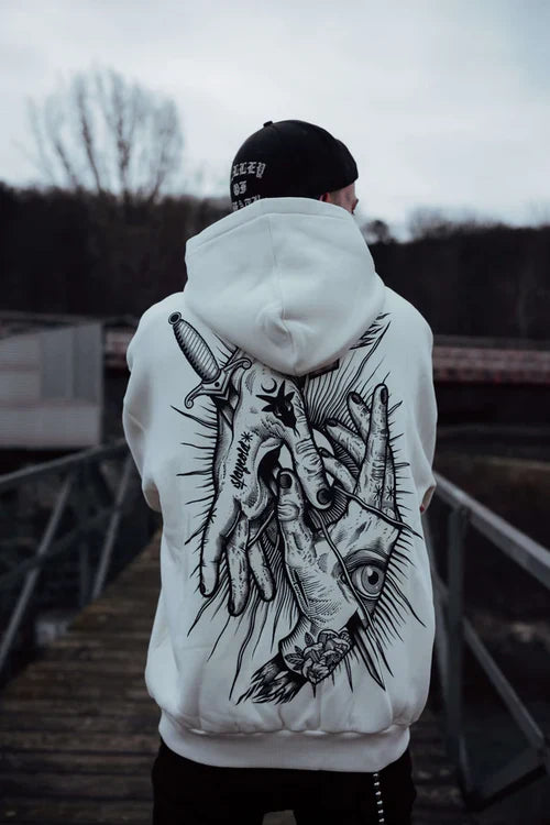 White graphic hoodie with dark surreal art and dagger-eye motif – urban streetwear fashion
